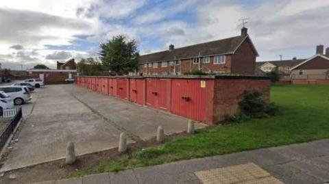 A line of garages and a forecourt