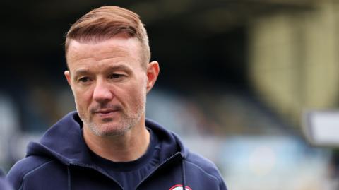 Noel Hunt waiting to speak to media following a Reading match