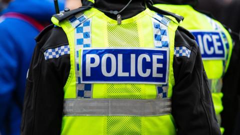 A generic shot of the back of a police officers jacket. 