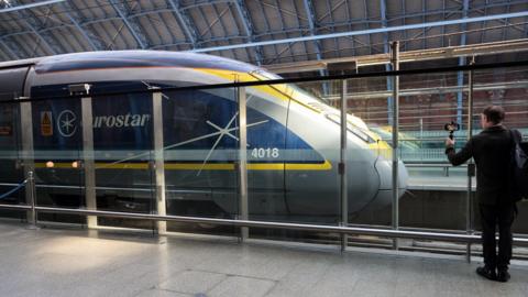 A man seen standing next to a Eurostar trais in London St Pancras station