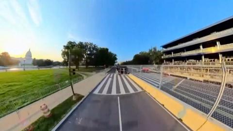 Fisheye view of a road with US Capitol on the left side.