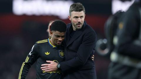 Manchester United winger Amad Diallo (left) with head coach Michael Carrick