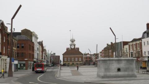 Stockton town centre. An old town hall is in the background with a clock tower. The area looks empty on the day the photograph was taken.