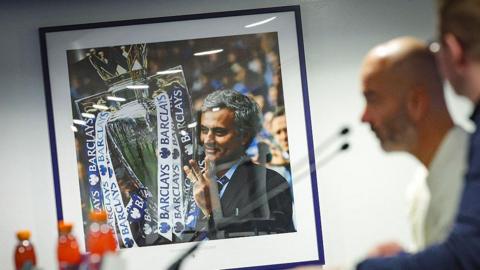Picture of Jose Mourinho holding trophies on the wall at Chelsea's Drake Suite.