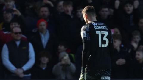 Milwall keeper Liam Roberts walks off after being sent off