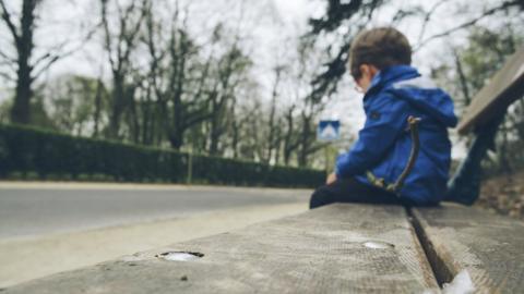 Boy sitting on a bench