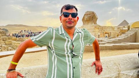 Ketan Shah on holiday in Egypt, wearing a green shirt and sunglasses, posing for a photo