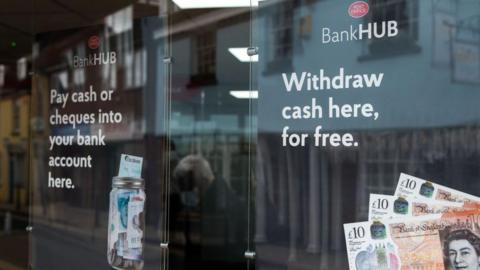 Signage in the window of the new Bank Hub