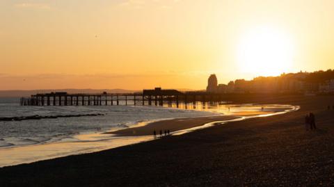 A sunset on a coastal English town. 