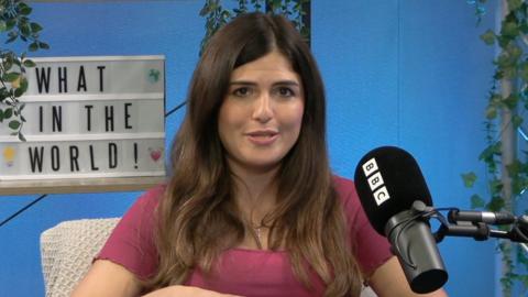 Hannah in the What in the World studio speaking