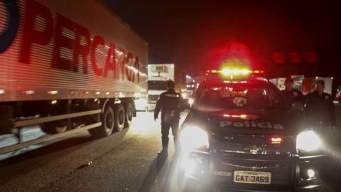 Police try to clear a blocked road in the city of Sao Bernardo do Campo during the sixth day of a truckers' strike on May, 26, 2018