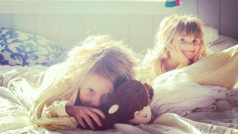 Two girls waking up