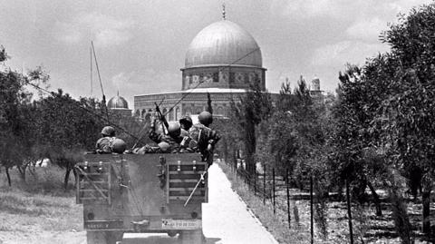 Israeli soldiers advance towards the Dome of the Rock