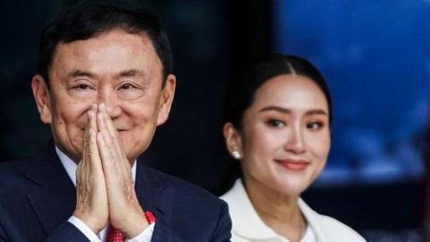 Thaksin Shinawatra greets his supporters with his youngest daughter Paetongtarn Shinawatra on August 22, 2023.