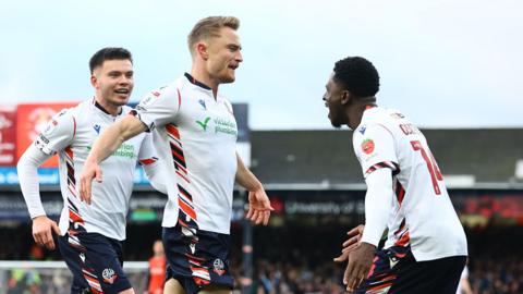 Bolton players celebrate Kyle Dempsey's goal at Luton