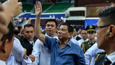 Philippine president Rodrigo Duterte waves to the crowds