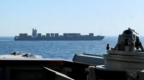 An image of a cargo ship from the guided missile destroyer USS Spruance