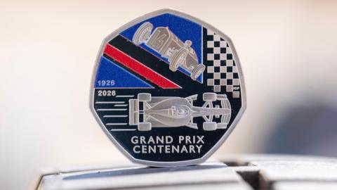 Its "tails" side showing a historic racing car from the original 1926 Brooklands race alongside a 2026 Formula 1 car.