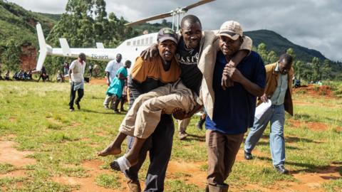 A wounded survivor is evacuated by helicopter from Chimanimani on March 19, 2019 to an hospital in Mutare,