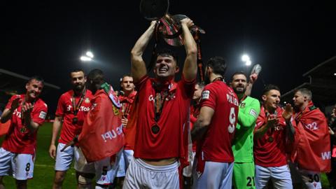 Jordan Davies and Wrexham players celebrate the National League title win