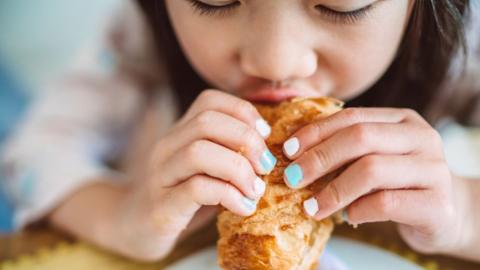 A girl eating a pastry