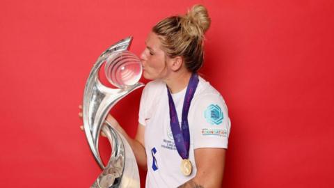 Millie Bright kisses the European Championship trophy after winning it with England in 2022