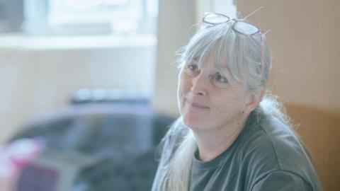 Kerry Jenkins wearing a grey t-shirt