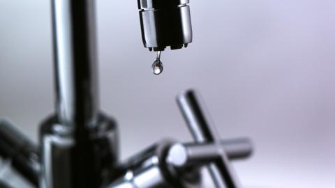 Water dripping out of a tap