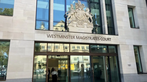 The exterior of Westminster magistrates court. It is a light stone building with long 