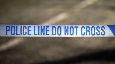  Police tape reading 'Police line do not cross'