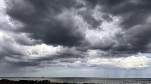 Dark grey rain clouds above the coast 