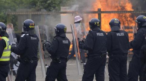 Armed police during an anti-immigration demonstration outside the Holiday Inn Express in Rotherham, South Yorkshire. 
