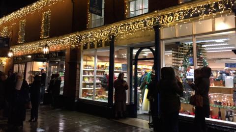 Shops festooned with Christmas lights in the dark