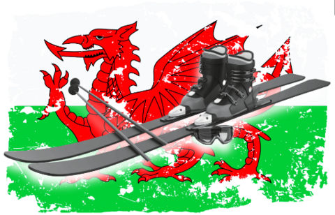 a pair of skis, boots and poles set on top of the flag of Wales