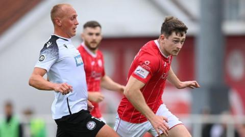 Karl O'Sullivan of Sligo Rovers in action against Kieran Smith of Bala Town