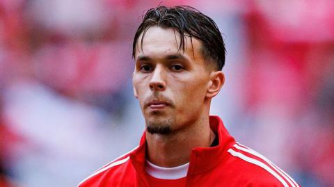 Amar Dedic pictured in a Benfica tracksuit