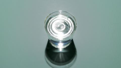 A glass of water on a duck egg background