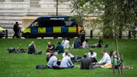 Groups of over six people socialise in Saint James' Park in Westminster on September 09, 2020 in London, England