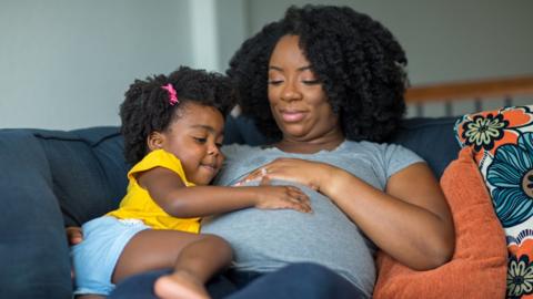 Pregnant mother with young daughter