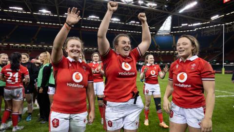 Lleucu George, Carys Phillips and Alisha Butchers celebrate victory over Italy at the Principality Stadium