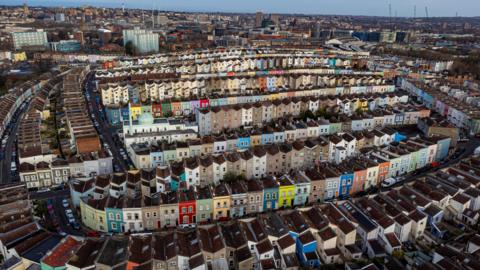 An aerial photo of colourful houses in Totterdown, with other areas of Bristol in the background.