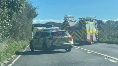 The crash on the A259 with a police car blocking the road and a fire engine