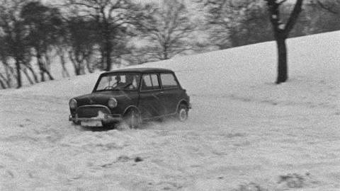 A mini doing a handbrake turn in the snow