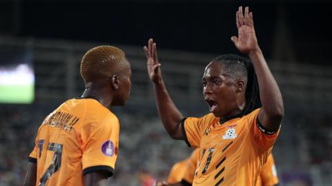 Zambia captain Barbra Banda raises both hands in the air as she celebrates a goal with team-mate Racheal Kundananji
