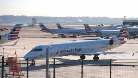 American arlines jets park on the runway of the Reagan National Airport on 30 January