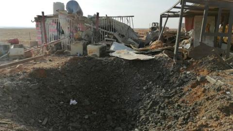 A hole left after an air strike at the headquarters of the Kataib Hezbollah militia group in Qaim, Iraq, on 30 December 2019