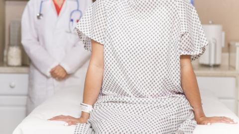 Stock photo of woman in hospital gown