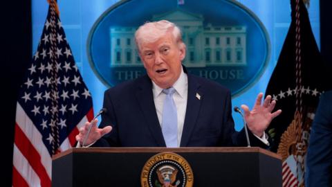 Trump speaking at podium