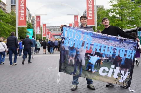 Two lads holding a City flag