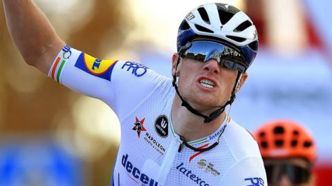 Sam Bennett puts his hands up in celebration after winning stage four of the Vuelta a Espana